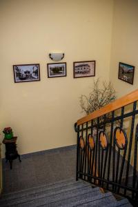 a room with a staircase with pictures on the wall at Apartments Masera in Kobarid