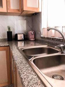 a kitchen with a sink and a counter top at Casa Sambinho Gerês in Rio Caldo +34 photos