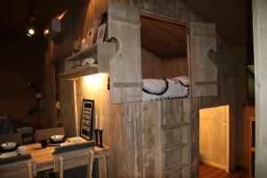 a wooden door in a room with a table at Frei wie der Wind-Glamping in Dierhagen
