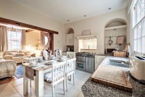 a kitchen and living room with a table and a couch at The Cottage in Chester, Sleeps 6 with FREE Parking in Chester