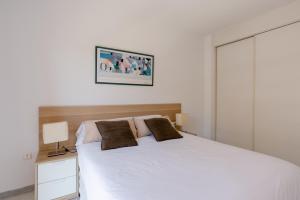 Posteľ alebo postele v izbe v ubytovaní Apartamento Residencial Bajondillo