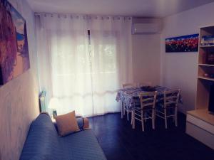 a living room with a couch and a table and a window at Caletta Beach in Castiglioncello