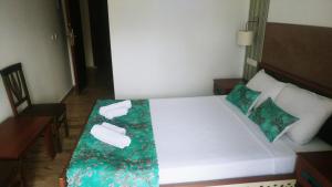 a bedroom with a bed with towels on it at Nehir Dalyan Boutique Otel in Ortaca