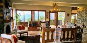 a living room filled with furniture and a fireplace at Villa The sky village in Jarabacoa