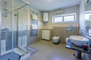 a bathroom with a sink and a shower and a toilet at Apartment Tus A1 in Crikvenica +42 photos