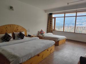Voodi või voodid majutusasutuse Hotel BHRIGU toas