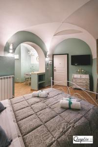 a bedroom with a large bed with two pillows on it at CHAPLIN Luxury Holiday House in Viterbo