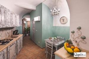 a kitchen with a table with fruit on the counter at CHAPLIN Luxury Holiday House in Viterbo