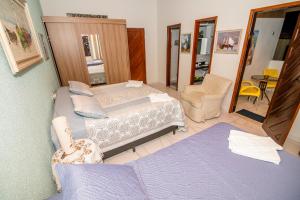 a small bedroom with a bed and a mirror at POUSADA TIA LUCY in Natal +46 photos