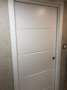a door in a bathroom with white paint at Bertoko Urdaibai II in Bermeo