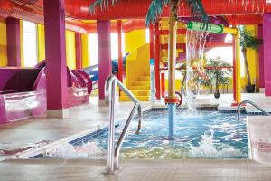 a pool with a water slide in a water park at Comfort Suites Regina in Regina