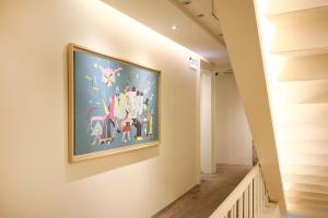 
a painting on a wall of a room with a painting on the wall at Quarantine Hotel - Dandy Hotel - Tianjin Branch in Taipei
