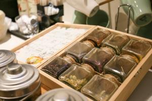 a tray of gold trays of food on a table at Dandy Hotel - Tianjin Branch in Taipei