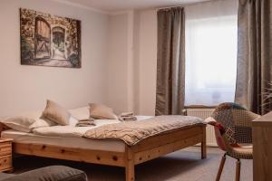 a bedroom with a bed and a window at Penzion Pohoda in Frymburk