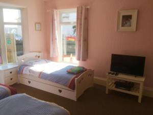 Gallery image of SINGER HOUSE ,PAIGNTON SEAFRONT ,SLEEPS 6 , 2 BEDROOM GROUND FLOOR SELF CONTAINED GARDEN FLAT , PRIVATE ENTRANCE , KITCHEN , Guaranteed Parking ,Wifi , Movies ,Bathroom ,fridge , microwave ,BEDROOM 1, DOUBLE BED & 2 SINGLE BEDS ,BEDROOM 2 , DOUBLE BED in Paignton