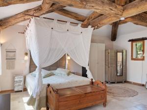 a bedroom with a bed with a canopy at VIlla in Bargemon with Private Swimming Pool in Bargemon