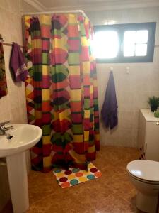 a bathroom with a colorful shower curtain and a sink at Love Yaiza in Yaiza