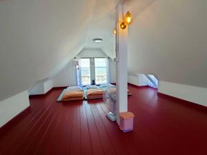 a attic room with two beds and a staircase at Pran sea & sun 2 in Pran Buri