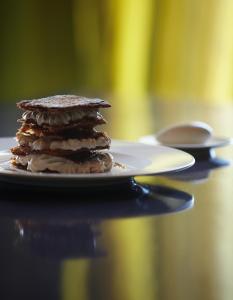 a stack of chocolate pancakes on a plate on a table at The Vine Hotel in Funchal