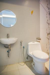 a bathroom with a white toilet and a sink at HOTEL PANTES SIMPANG LIMA SEMARANG in Semarang