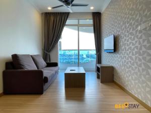 a living room with a couch and a tv at The Wave Suites Melaka in Melaka
