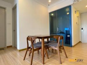 a wooden table with two chairs and a dining room at The Wave Suites Melaka in Melaka