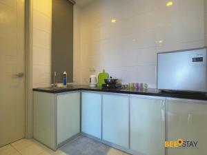 a kitchen with a counter with a tv on it at The Wave Suites Melaka in Melaka