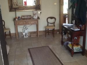 a room with a desk and two chairs and a table at Carrigshane House in Midleton +16 photos