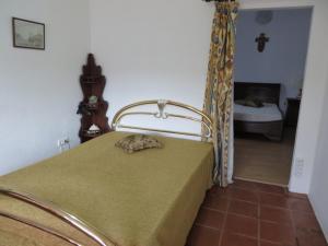 a bedroom with a bed with a green comforter at Sol Poente in Évora +83 photos