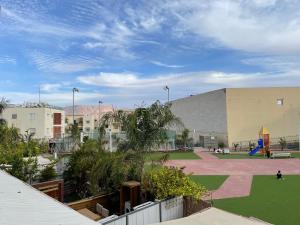 a large building with a playground in a park at Apartament - Lev Eilat 8 in Eilat