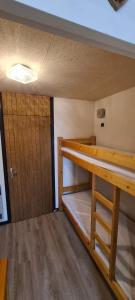 a room with two bunk beds and a door at Le Bois Joli in Saint-Pierre-de-Chartreuse