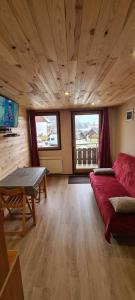 a living room with a couch and a table at Le Bois Joli in Saint-Pierre-de-Chartreuse