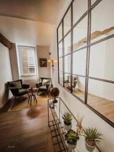 a living room with a large window and plants at L'AccrocheCoeur in Saint Malo