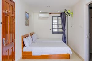 Ένα ή περισσότερα κρεβάτια σε δωμάτιο στο Bach Duong Hotel
