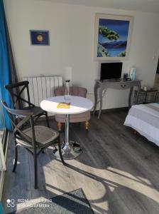 a room with a table and a bed and a desk at Mas de Grezes in Gaillac