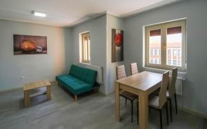 a living room with a green couch and a table at La Casita de la Neka in Villarcayo