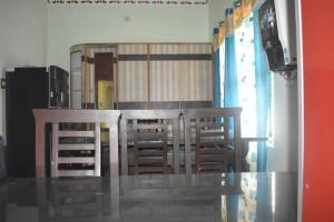a dining room table and chairs in a room at Reunion Villa Abode in Udupi