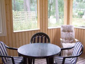 a table and chairs in a room with a window at 5 person holiday home in MELLBYSTRAND in Mellbystrand