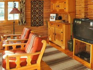 a living room with two chairs and a television at Four-Bedroom Holiday home in Olden 1 in Olden
