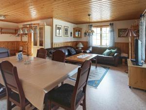 a living room with a table and a couch at 6 person holiday home in TORSBY in Överbyn