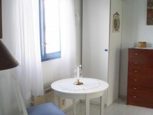 a small white table in a room with a window at One-Bedroom Holiday home in Stenungsund in Stenungsund