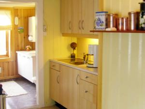 a kitchen with a sink and a counter top at 6 person holiday home in lyngdal in Lyngdal