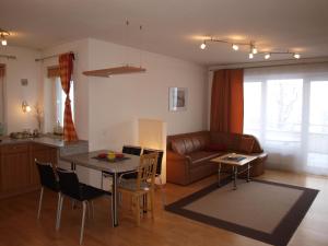 a living room with a couch and a table at Superior Appartement Schiwiese in Bad Hofgastein