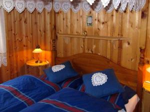 a bedroom with a bed with blue pillows at Two-Bedroom Holiday home in Utvik 1 in Sølberg
