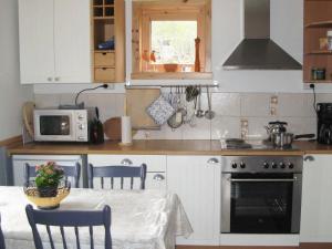a kitchen with a table and a stove top oven at 6 person holiday home in ALSV G in Gisløy