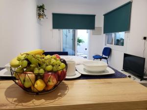 a table with a bowl of fruit on top of it at Modern & Cozy Studio w/ Backyard Near City Center in Limassol
