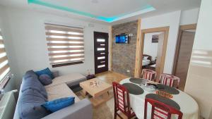 a living room with a couch and a table at Apartmani Dunja Zlatar in Nova Varoš