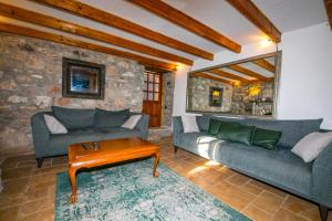 a living room with two couches and a coffee table at Villa Cottage Söğüt Marmaris Daily Weekly Rentals in Mugla
