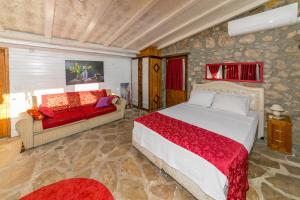 a bedroom with a large bed and a couch at Villa Cottage Söğüt Marmaris Daily Weekly Rentals in Mugla +41 photos