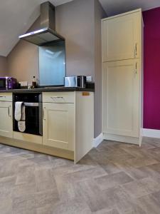 a kitchen with a stove and a sink at Bryn Melyn Apartments in Barmouth
